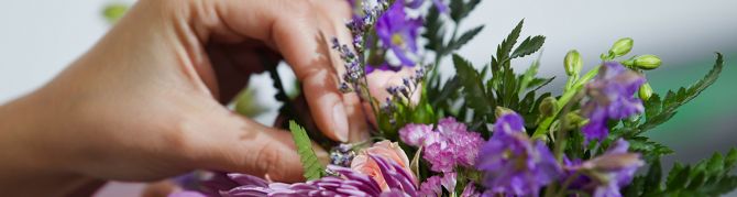 Florist adjusting the position of flowers in a bouquet