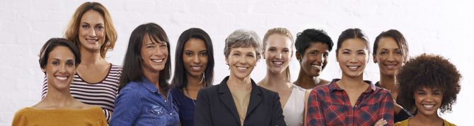 Ten ladies standing together, smiling for a picture