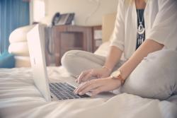 Woman on bed with laptop
