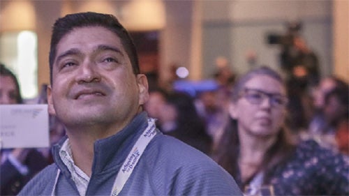 Achieving the Dream Network Connection newsletter cover featuring an attendee listening during a higher education event.