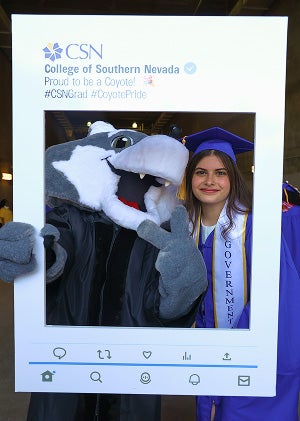 Student celebrating graduation with CSN mascot