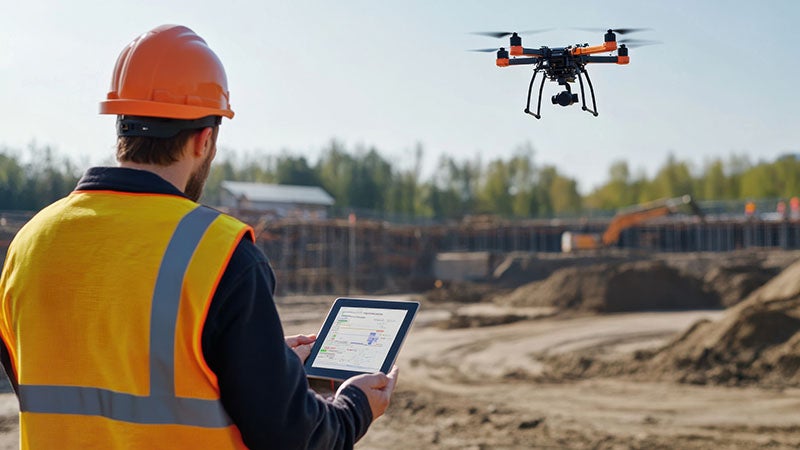 Man flying a drone during a land survey.