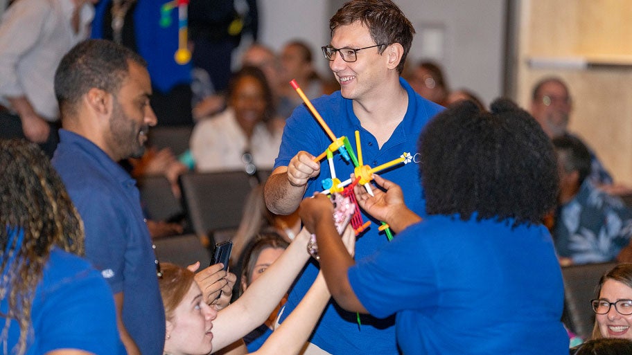 CSN faculty collaborate on a hands-on building activity during a group workshop.
